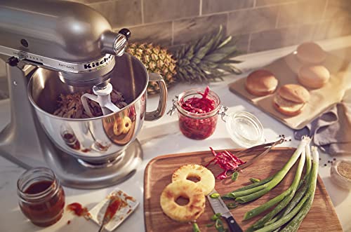 KitchenAid stand mixer with attachments and bowl on kitchen counter